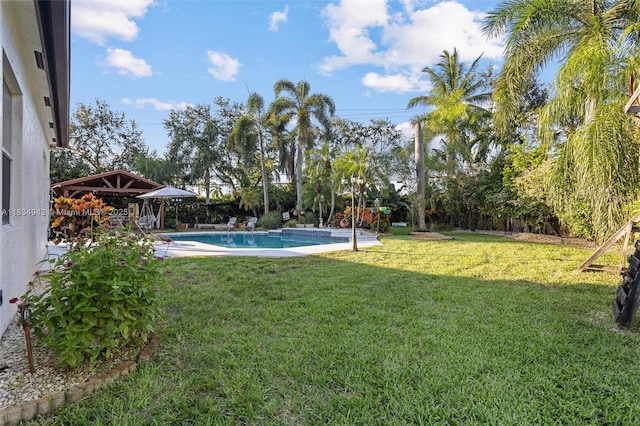 14501 SW 33rd Ct, Miramar, FL 33027 - view of green lawn with an outdoor pool