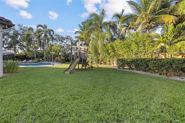 14501 SW 33rd Ct, Miramar, FL 33027 - view of green lawn featuring a playground and an outdoor pool