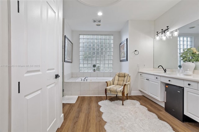14501 SW 33rd Ct, Miramar, FL 33027 - full bathroom with vanity, a garden tub, and wood finished floors
