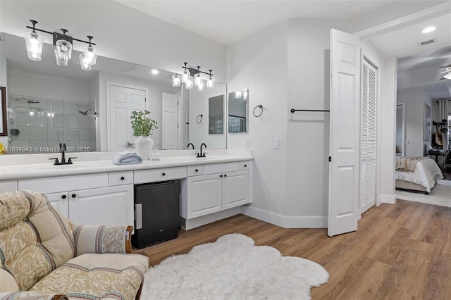 14501 SW 33rd Ct, Miramar, FL 33027 - bathroom with double vanity, wood finished floors, a stall shower, recessed lighting, and a closet
