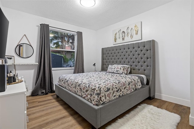 14501 SW 33rd Ct, Miramar, FL 33027 - bedroom with light wood-type flooring and a textured ceiling