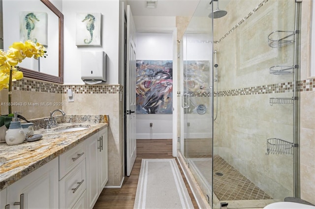 14501 SW 33rd Ct, Miramar, FL 33027 - bathroom with a shower stall, vanity, wood finished floors, and tile walls