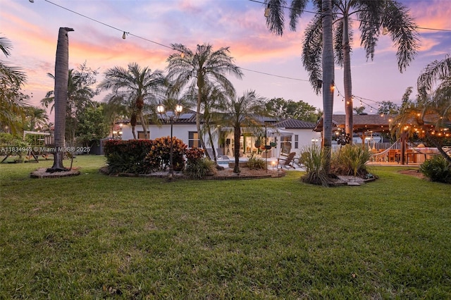 14501 SW 33rd Ct, Miramar, FL 33027 - back of house at dusk with a yard and stucco siding