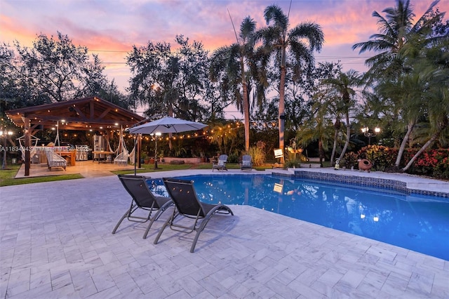 14501 SW 33rd Ct, Miramar, FL 33027 - pool at dusk featuring a gazebo, an outdoor pool, and a patio
