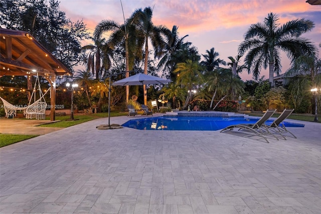 14501 SW 33rd Ct, Miramar, FL 33027 - pool at dusk featuring a patio and an outdoor pool