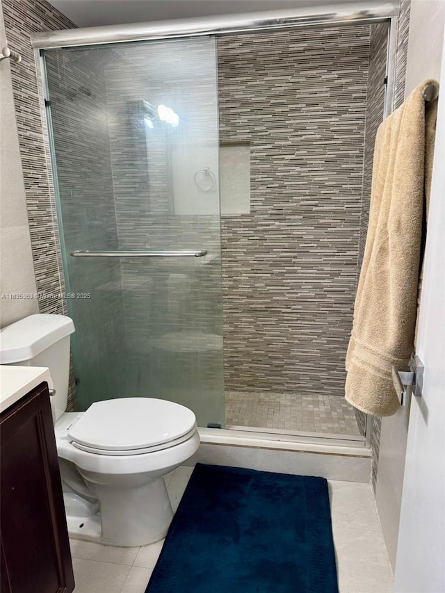 201 180th Dr Unit 114, Sunny Isles Beach, FL 33160 - bathroom with tile patterned flooring, a stall shower, and vanity