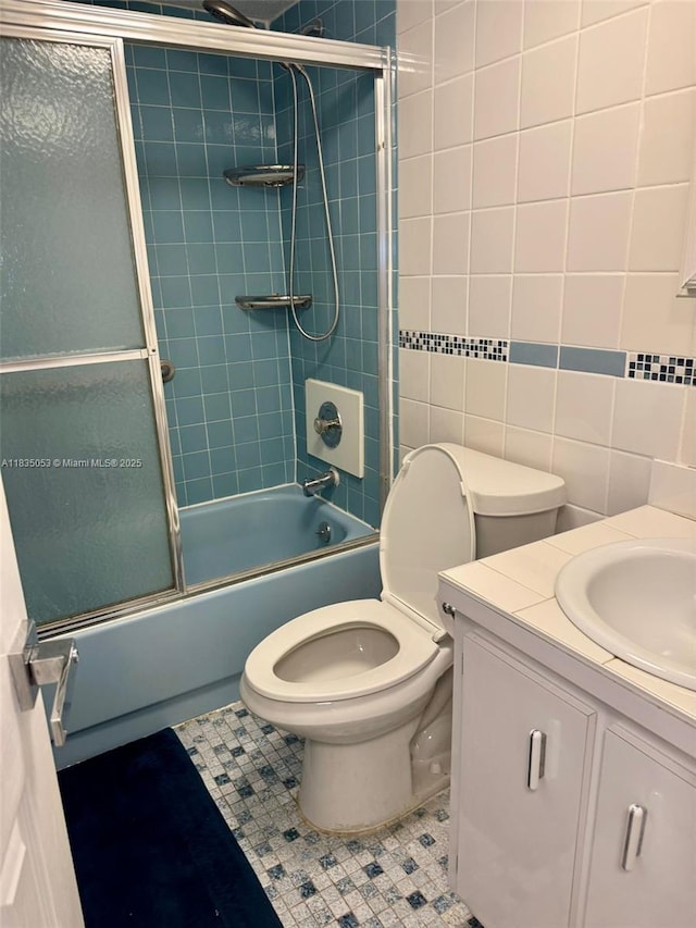 201 180th Dr Unit 114, Sunny Isles Beach, FL 33160 - full bath with enclosed tub / shower combo, vanity, tile patterned flooring, and tile walls