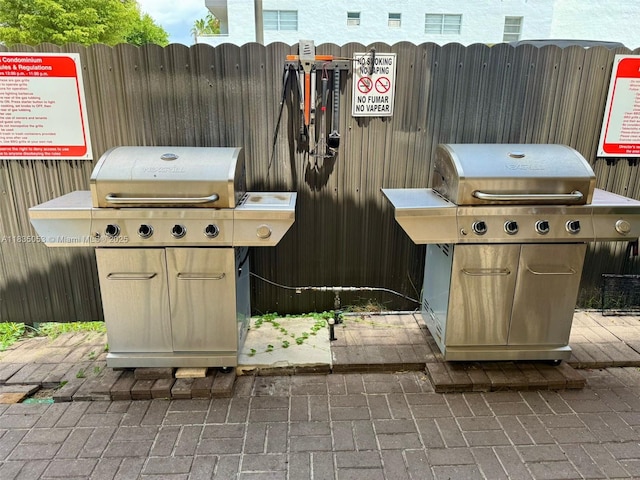 201 180th Dr Unit 114, Sunny Isles Beach, FL 33160 - view of patio featuring grilling area and pet washing area