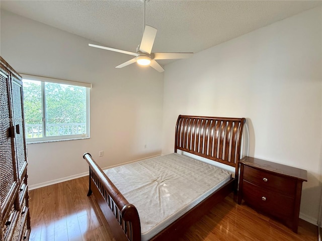 9575 Weldon Cir Unit C406, Tamarac, FL 33321 - bedroom with wood finished floors, a textured ceiling, and ceiling fan