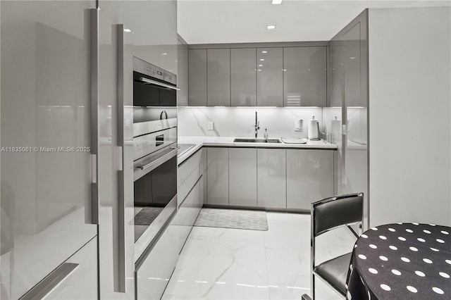 8877 Collins Ave Unit 705, Surfside, FL 33154 - kitchen featuring gray cabinets, modern cabinets, light marble finish floors, freestanding refrigerator, and light countertops