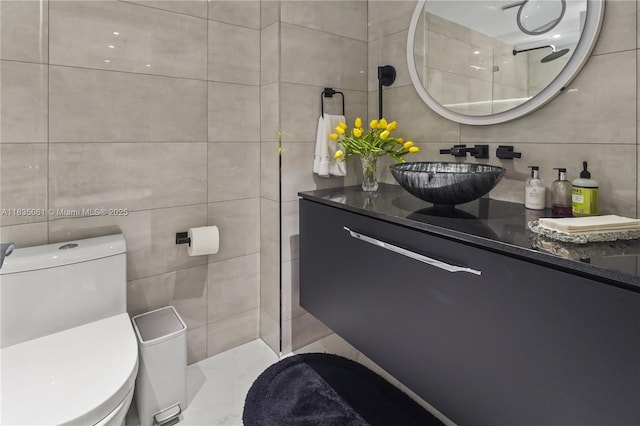 8877 Collins Ave Unit 705, Surfside, FL 33154 - bathroom featuring tile walls, vanity, marble finish flooring, and decorative backsplash