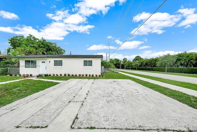 5201 Wiley St, Hollywood, FL 33021 - ranch-style house with stucco siding, a front lawn, and driveway