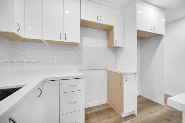 5201 Wiley St, Hollywood, FL 33021 - kitchen featuring white cabinetry, backsplash, light wood finished floors, and modern cabinets
