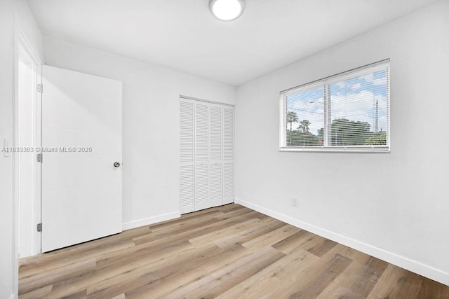 5201 Wiley St, Hollywood, FL 33021 - unfurnished bedroom featuring wood finished floors and a closet