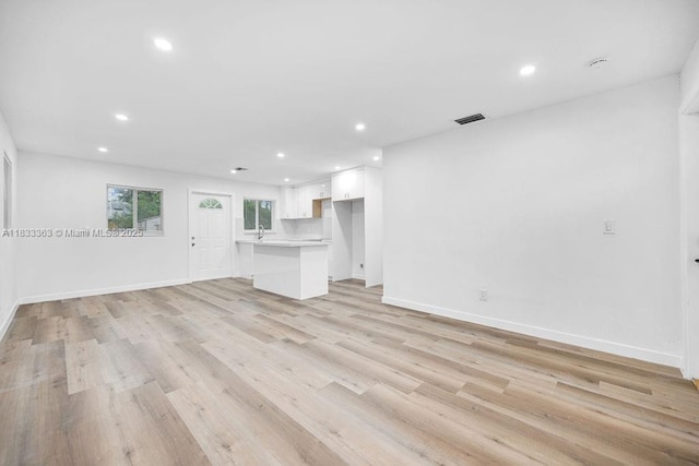5201 Wiley St, Hollywood, FL 33021 - unfurnished living room with recessed lighting and light wood-style floors