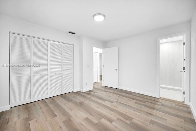 5201 Wiley St, Hollywood, FL 33021 - unfurnished bedroom with a closet, wood finished floors, and ensuite bathroom