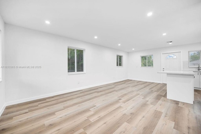 5201 Wiley St, Hollywood, FL 33021 - unfurnished living room featuring light wood-style floors, plenty of natural light, and recessed lighting