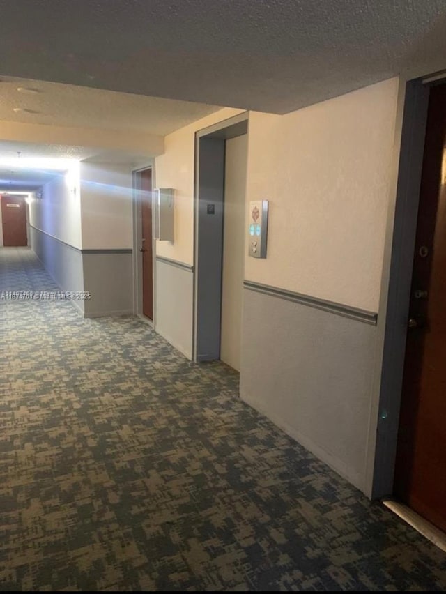 250 181st Dr Unit 212, Sunny Isles Beach, FL 33160 - hallway with carpet flooring, elevator, and a textured ceiling