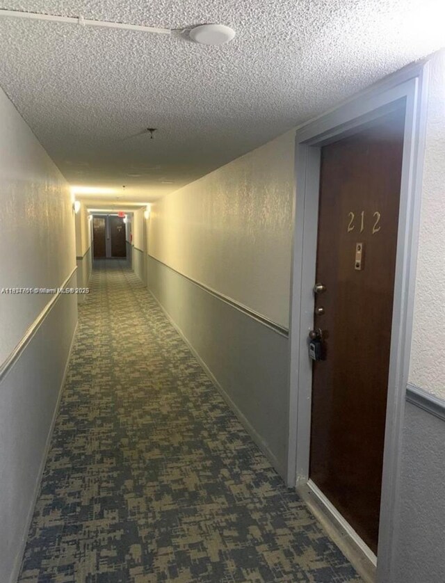 250 181st Dr Unit 212, Sunny Isles Beach, FL 33160 - corridor featuring a textured ceiling