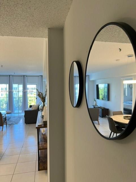 250 181st Dr Unit 212, Sunny Isles Beach, FL 33160 - corridor featuring light tile patterned floors and a textured ceiling