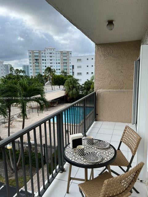 250 181st Dr Unit 212, Sunny Isles Beach, FL 33160 - balcony with view of pool and a city view