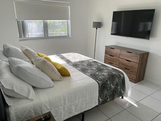 250 181st Dr Unit 212, Sunny Isles Beach, FL 33160 - bedroom with light tile patterned floors and baseboards
