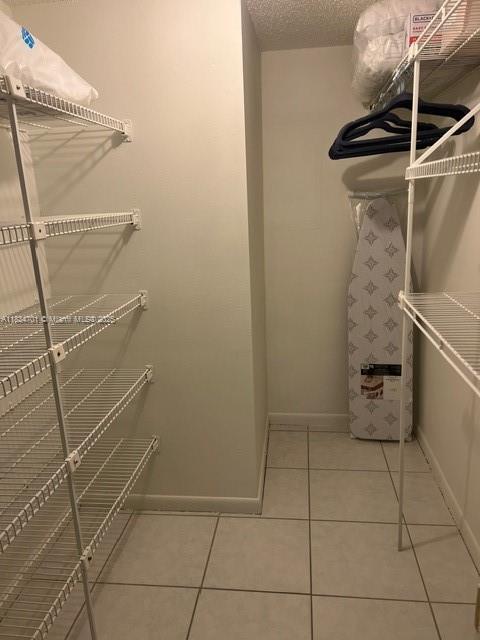 250 181st Dr Unit 212, Sunny Isles Beach, FL 33160 - walk in closet featuring light tile patterned flooring