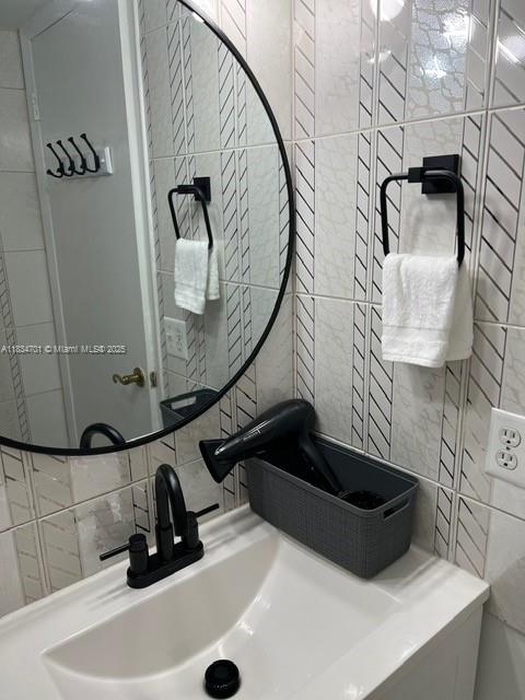 250 181st Dr Unit 212, Sunny Isles Beach, FL 33160 - bathroom with tile walls and decorative backsplash