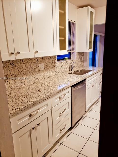 12600 SW 10th Ct, Davie, FL 33325 - kitchen with dishwasher, white cabinets, light stone countertops, and light tile patterned floors