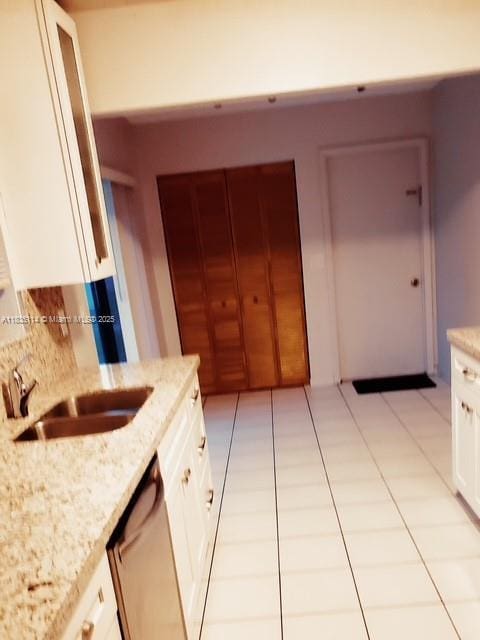 12600 SW 10th Ct, Davie, FL 33325 - kitchen with dishwasher, white cabinets, light stone countertops, light tile patterned floors, and backsplash