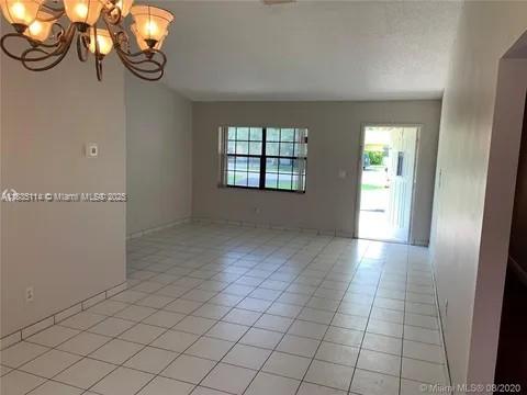 12600 SW 10th Ct, Davie, FL 33325 - unfurnished room featuring a chandelier and light tile patterned floors