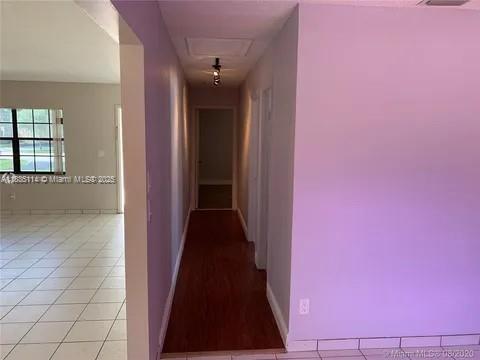 12600 SW 10th Ct, Davie, FL 33325 - corridor with baseboards and light tile patterned floors