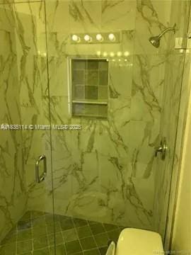 12600 SW 10th Ct, Davie, FL 33325 - full bathroom featuring a marble finish shower and toilet