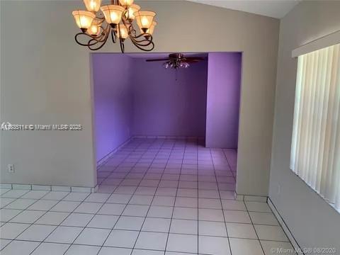 12600 SW 10th Ct, Davie, FL 33325 - empty room with a chandelier and light tile patterned flooring