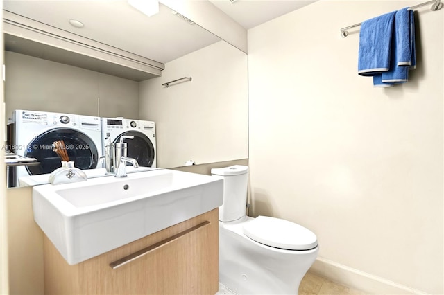 3530 Mystic Pointe Dr Unit 1714, Aventura, FL 33180 - half bathroom with washing machine and clothes dryer, vanity, and tile patterned floors