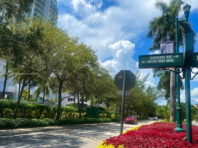 3530 Mystic Pointe Dr Unit 1714, Aventura, FL 33180 - view of asphalt road featuring traffic signs and curbs