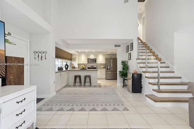 304 Andover Ct, Boynton Beach, FL 33436 - entryway featuring a high ceiling, light tile patterned floors, and stairway