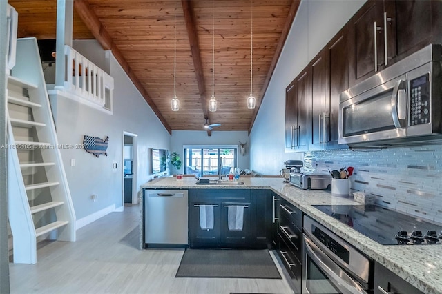 10391 Jasmine Ct, Pembroke Pines, FL 33026 - kitchen featuring appliances with stainless steel finishes, decorative backsplash, a peninsula, light wood finished floors, and a wood ceiling with exposed beams
