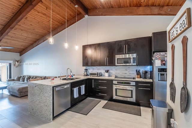 10391 Jasmine Ct, Pembroke Pines, FL 33026 - kitchen with appliances with stainless steel finishes, wood ceiling, open floor plan, light wood-style flooring, and a peninsula