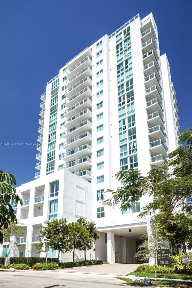 1871 NW S River Dr Unit 1904, Miami, FL 33125 - view of apartment building / complex with a carport