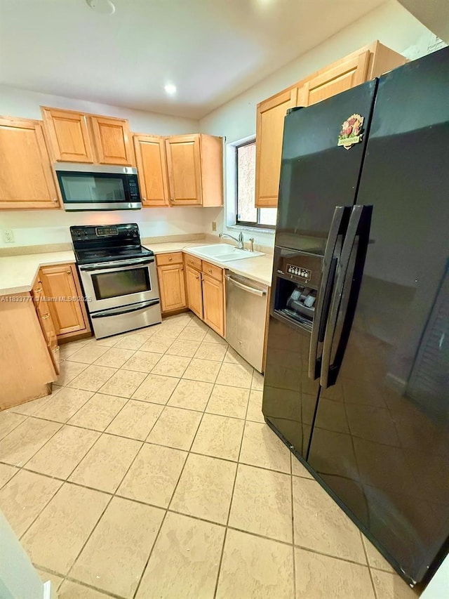 5012 SW 40th Ave Unit 5012, Fort Lauderdale, FL 33312 - kitchen featuring appliances with stainless steel finishes, light brown cabinetry, light countertops, light tile patterned floors, and recessed lighting