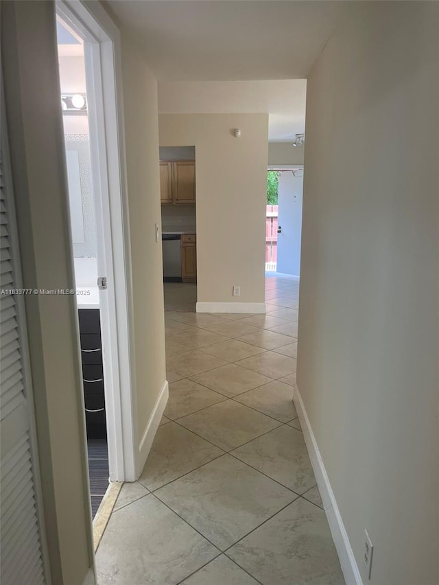 5012 SW 40th Ave Unit 5012, Fort Lauderdale, FL 33312 - corridor featuring baseboards and light tile patterned floors