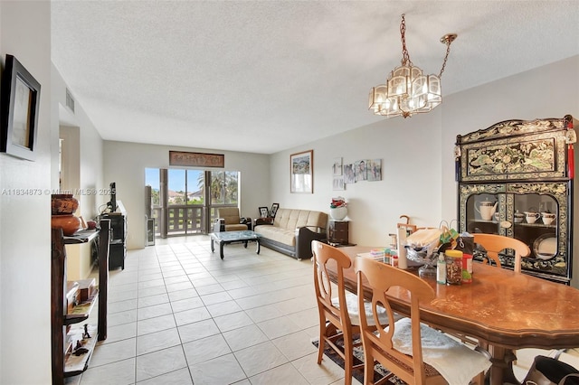 4350 Hillcrest Dr Unit 306, Hollywood, FL 33021 - dining space with a chandelier, a textured ceiling, and light tile patterned flooring