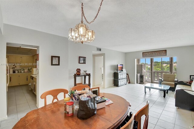 4350 Hillcrest Dr Unit 306, Hollywood, FL 33021 - dining area with light tile patterned floors, a chandelier, and a textured ceiling