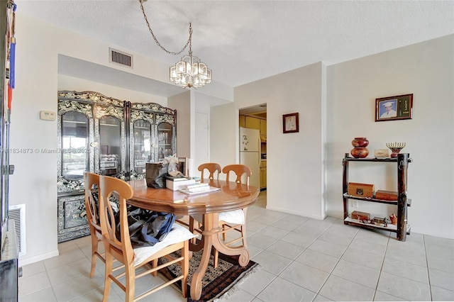 4350 Hillcrest Dr Unit 306, Hollywood, FL 33021 - dining area featuring a chandelier and light tile patterned flooring