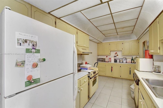 4350 Hillcrest Dr Unit 306, Hollywood, FL 33021 - kitchen featuring white appliances, under cabinet range hood, light tile patterned floors, light countertops, and cream cabinets