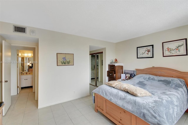 4350 Hillcrest Dr Unit 306, Hollywood, FL 33021 - bedroom featuring a closet, light tile patterned floors, and a textured ceiling