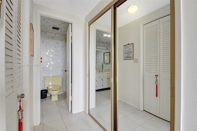 4350 Hillcrest Dr Unit 306, Hollywood, FL 33021 - corridor featuring light tile patterned flooring and wallpapered walls
