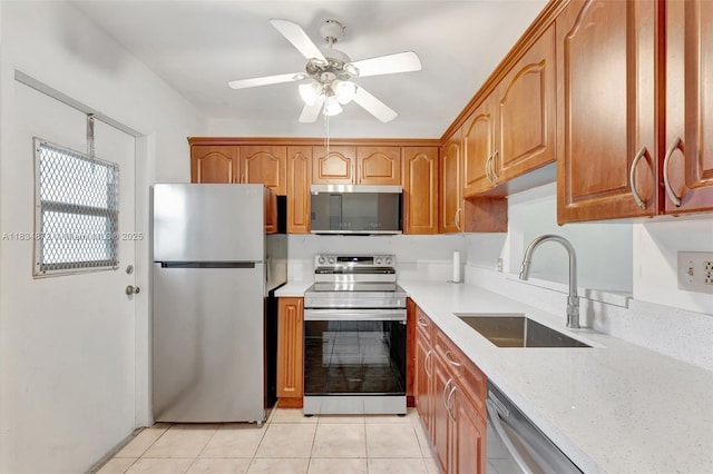 4341 NW 16th St Unit 203, Lauderhill, FL 33313 - kitchen featuring stainless steel appliances, a ceiling fan, light tile patterned floors, light stone counters, and brown cabinetry