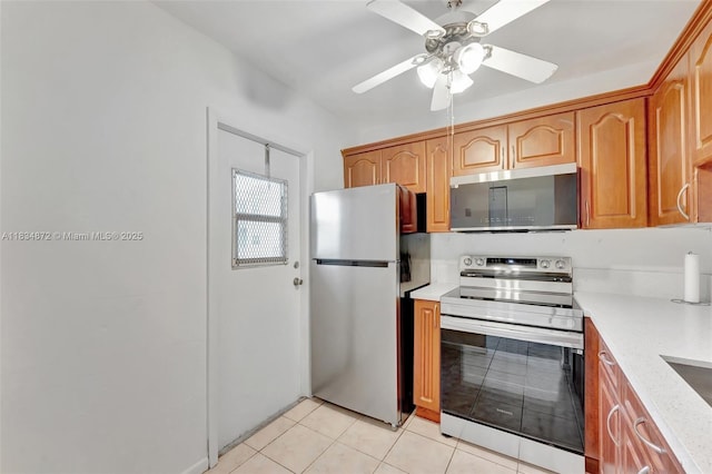 4341 NW 16th St Unit 203, Lauderhill, FL 33313 - kitchen featuring appliances with stainless steel finishes, light countertops, ceiling fan, light tile patterned flooring, and brown cabinets